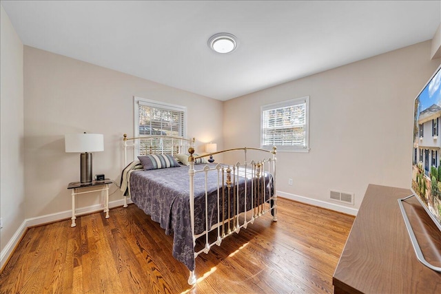 bedroom with hardwood / wood-style floors