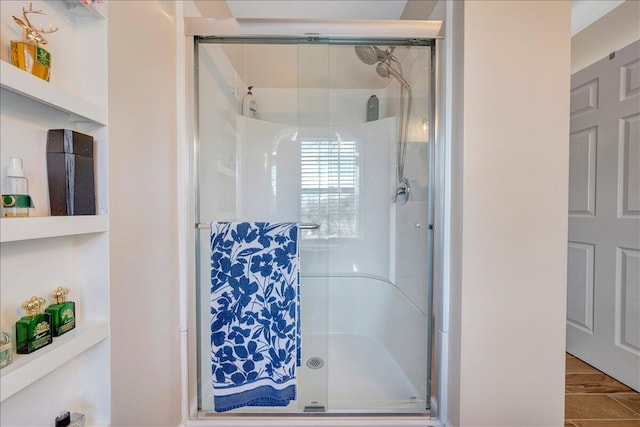 bathroom with hardwood / wood-style flooring, toilet, and walk in shower