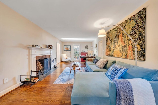 living room with hardwood / wood-style floors and a fireplace