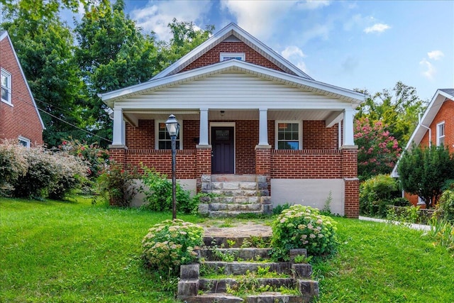 view of front of home with a front yard and a porch