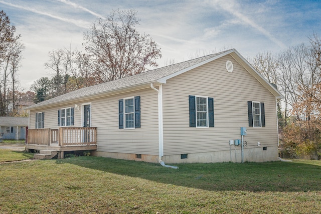 exterior space featuring a wooden deck and a yard