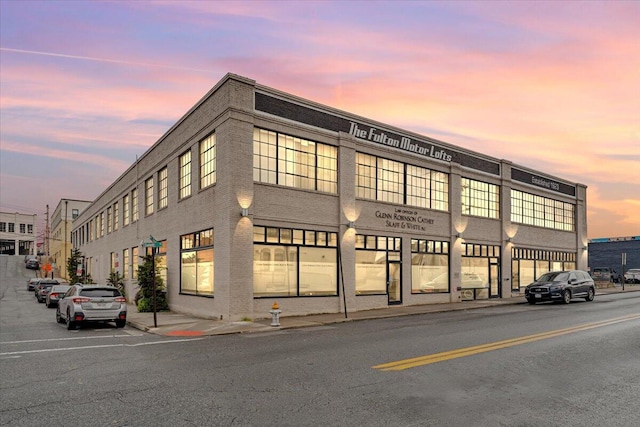 view of outdoor building at dusk