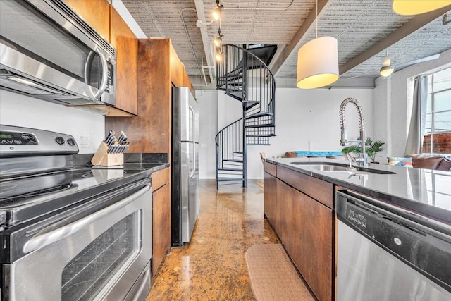 kitchen featuring sink, pendant lighting, and appliances with stainless steel finishes