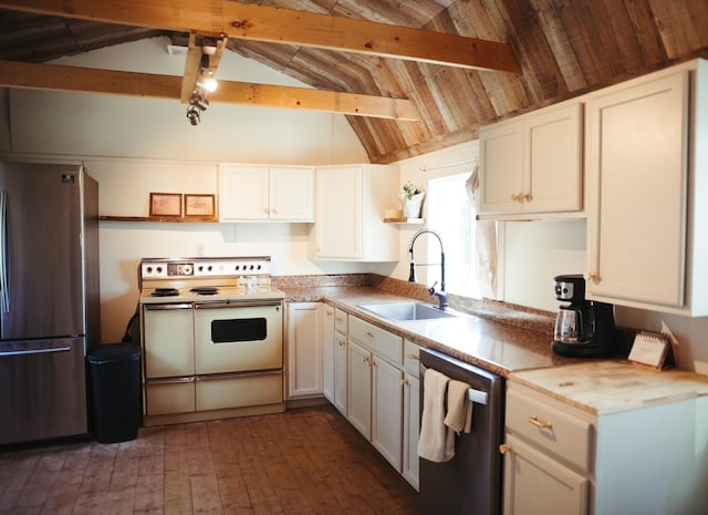 kitchen with white cabinets, lofted ceiling with beams, and stainless steel appliances