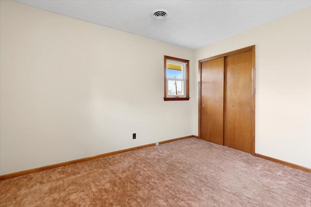 unfurnished bedroom featuring a closet and carpet