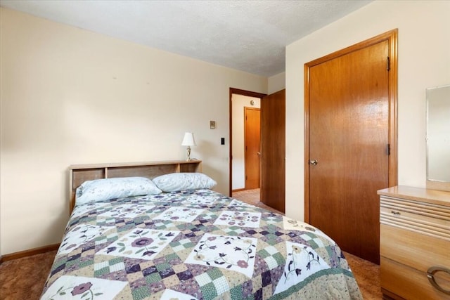 bedroom with a closet, carpet floors, and a textured ceiling