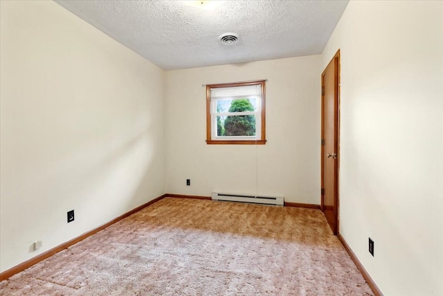 carpeted empty room featuring a textured ceiling and baseboard heating