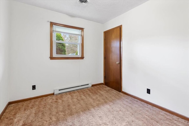 empty room with baseboard heating, carpet, and a textured ceiling