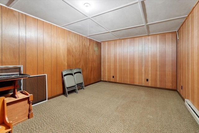 interior space featuring baseboard heating and wooden walls