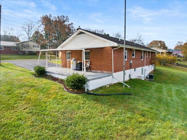 rear view of house featuring a yard, a patio, and central AC unit