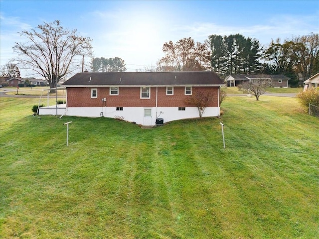 rear view of house featuring a yard