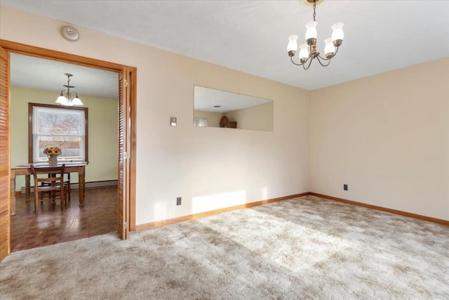 carpeted empty room with a chandelier