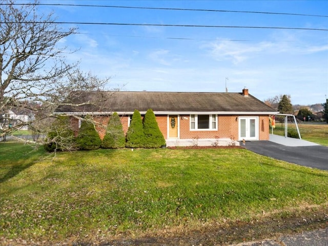 ranch-style house with a front lawn, french doors, and a carport