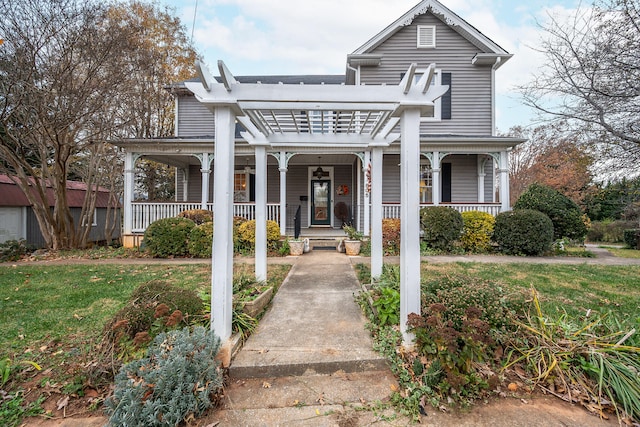 front of property with a front yard, a porch, and a pergola