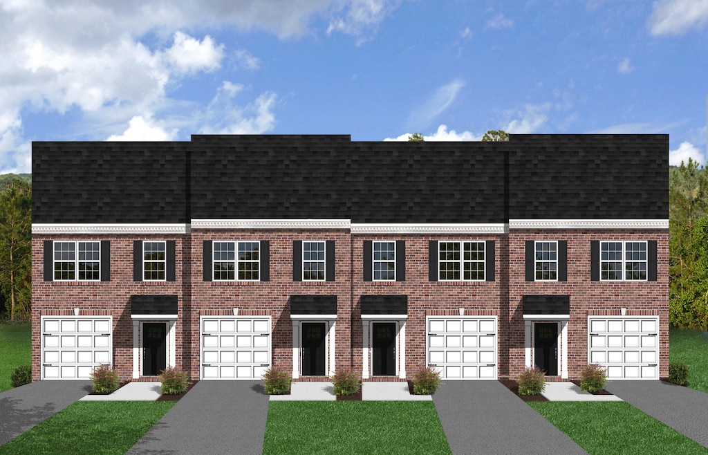 townhome / multi-family property with a front lawn