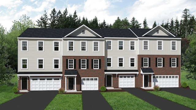 view of front of house with a front yard, driveway, an attached garage, brick siding, and board and batten siding