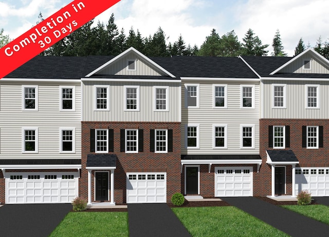 multi unit property with a garage, a front yard, brick siding, board and batten siding, and driveway