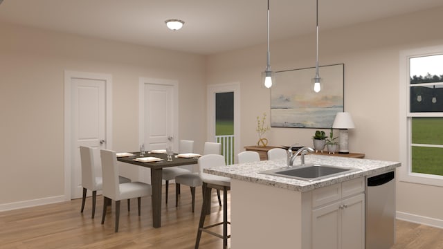 kitchen featuring light wood-type flooring, a sink, stainless steel dishwasher, light countertops, and baseboards