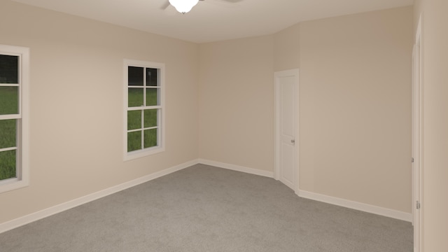 empty room featuring carpet flooring and baseboards