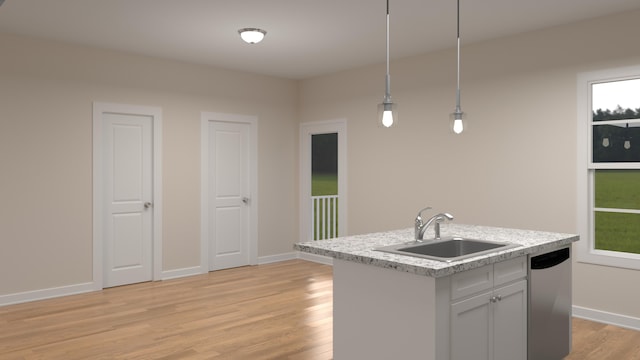 kitchen featuring light wood finished floors, a sink, light countertops, dishwasher, and decorative light fixtures