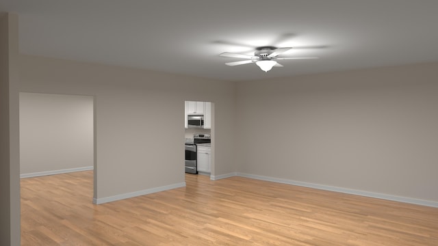 empty room featuring baseboards, light wood-type flooring, and ceiling fan