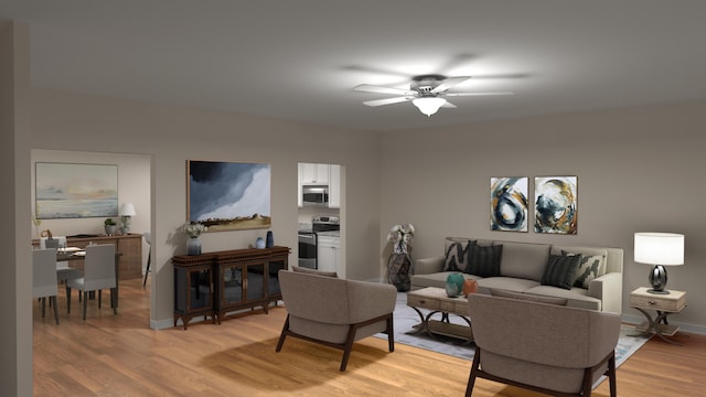 living area featuring a ceiling fan, baseboards, and light wood finished floors