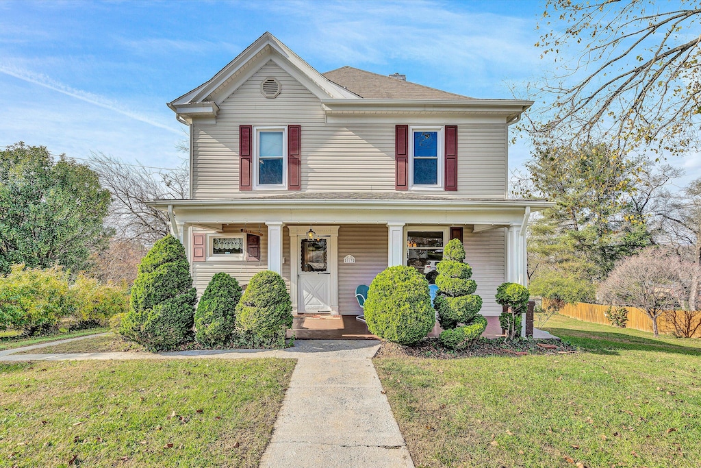 front facade with a front lawn and covered porch