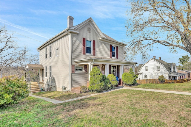 front facade with covered porch and a front lawn