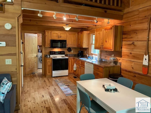 kitchen featuring light hardwood / wood-style floors, wood walls, sink, beam ceiling, and white appliances