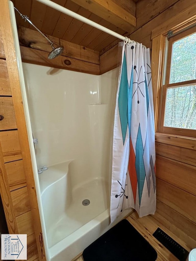 bathroom with a shower with curtain, wooden walls, wood ceiling, and hardwood / wood-style floors