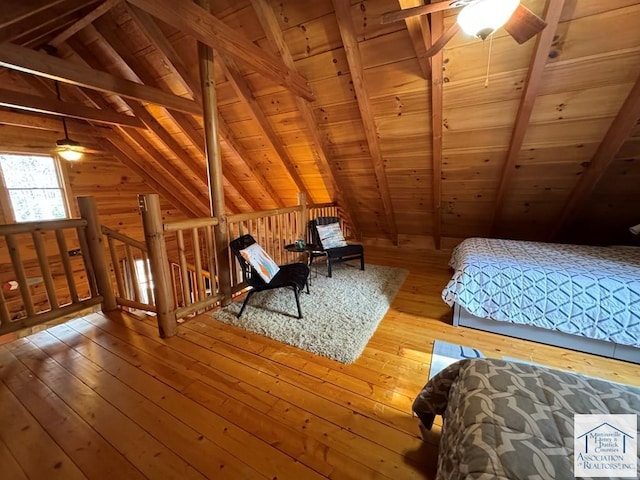 unfurnished bedroom featuring wooden ceiling, wood-type flooring, wood walls, and vaulted ceiling with beams