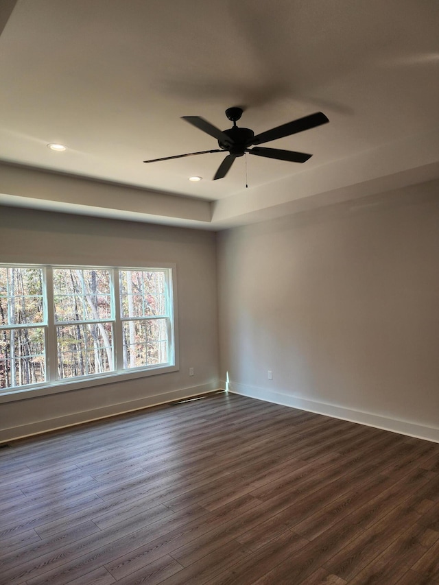 spare room featuring ceiling fan and dark hardwood / wood-style floors