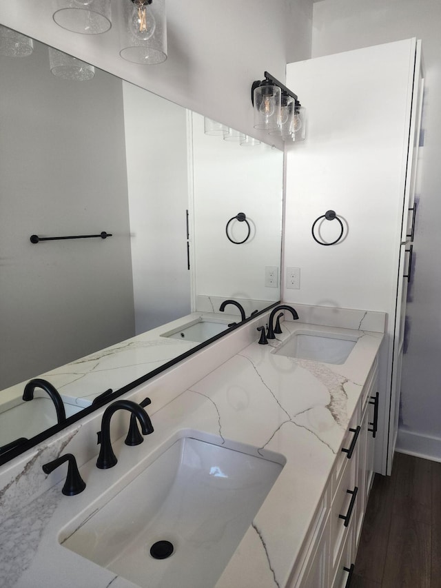 bathroom with hardwood / wood-style floors and vanity