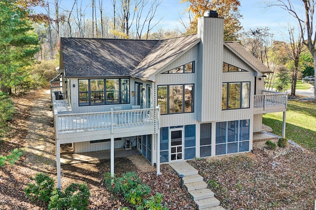 rear view of property with a sunroom