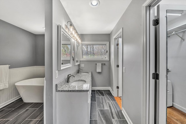 bathroom with vanity and a bathtub