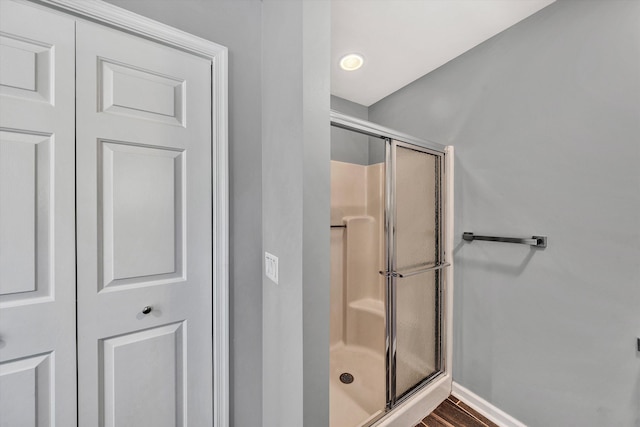 bathroom featuring walk in shower and hardwood / wood-style floors