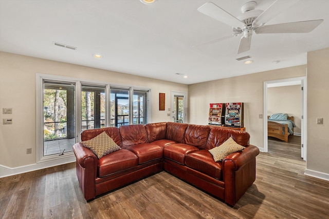 living room with dark hardwood / wood-style floors and ceiling fan