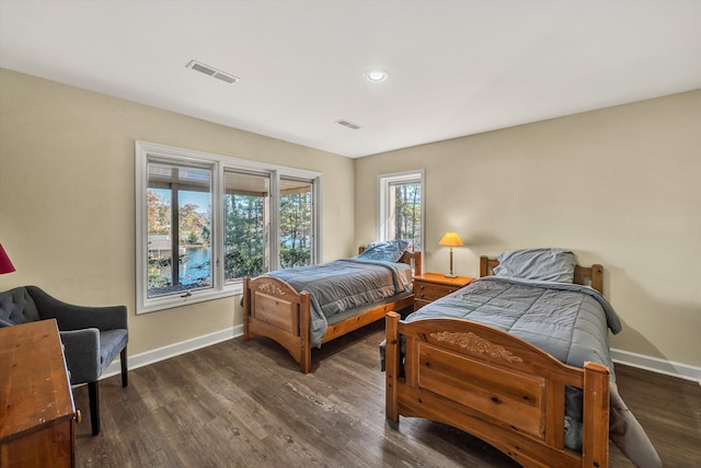 bedroom with dark hardwood / wood-style flooring