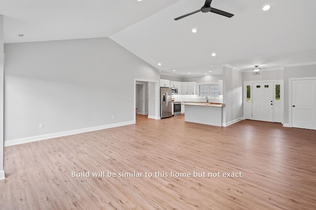 unfurnished living room featuring vaulted ceiling, sink, ceiling fan, crown molding, and light wood-type flooring