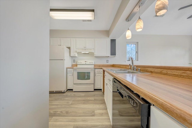 kitchen with white appliances, white cabinets, a sink, and under cabinet range hood