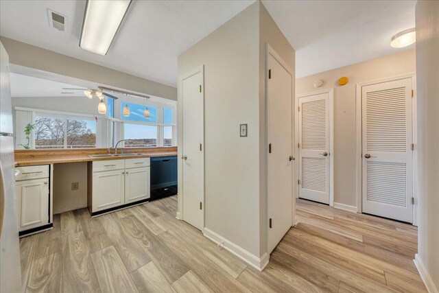 kitchen featuring wood counters, sink, white cabinetry, pendant lighting, and white appliances