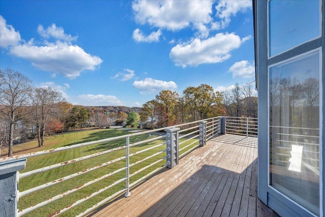 deck with a yard and a rural view