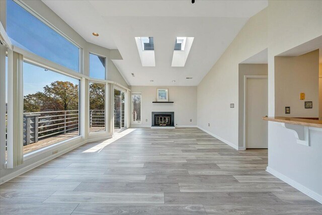 dining area with high vaulted ceiling, ceiling fan, and light wood-type flooring