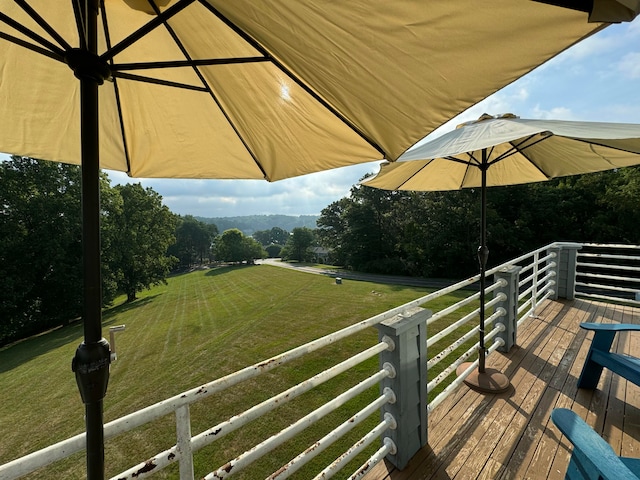 wooden deck featuring a yard