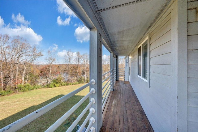 wooden deck featuring a yard