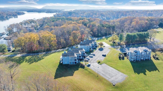 drone / aerial view featuring a wooded view