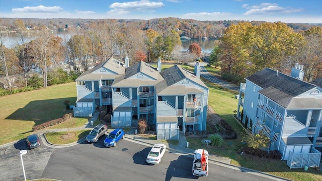 drone / aerial view with a water view and a view of trees