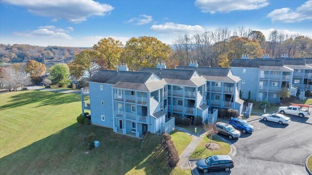 view of home's community with a deck and a lawn