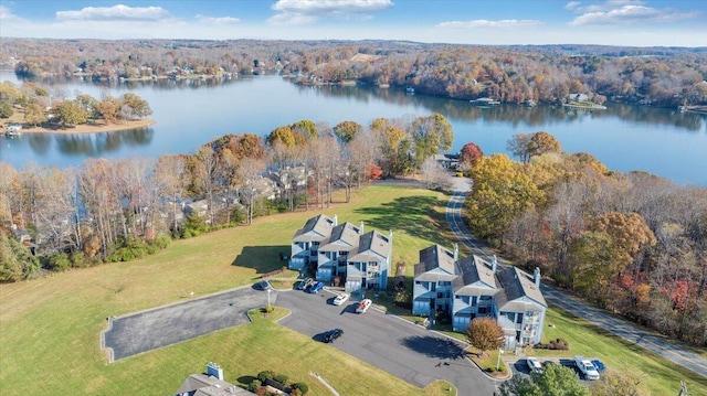 birds eye view of property featuring a water view and a view of trees