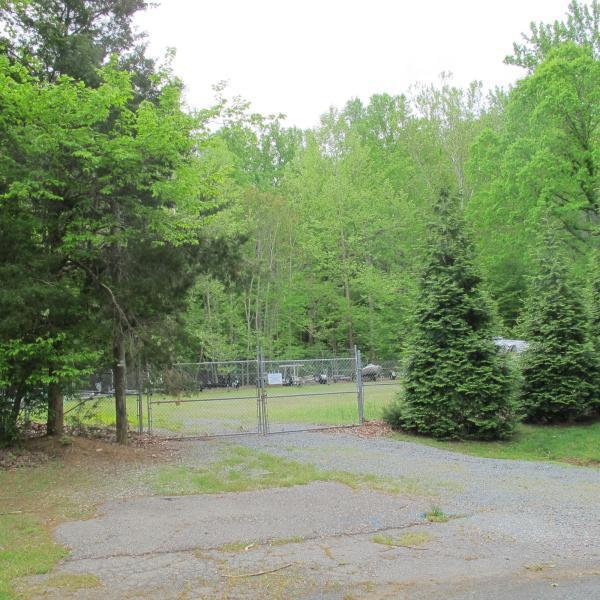 view of yard featuring a water view and a storage shed